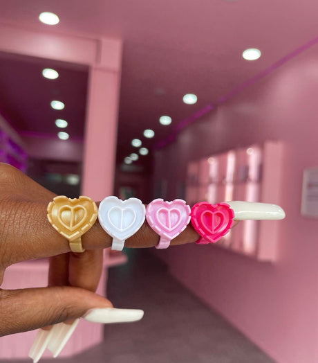 Heart glue ring worn on finger – part of 100-pack lash adhesive holders from Trish Co Heart glue ring worn on finger – part of 100-pack lash adhesive holders from Trish Co